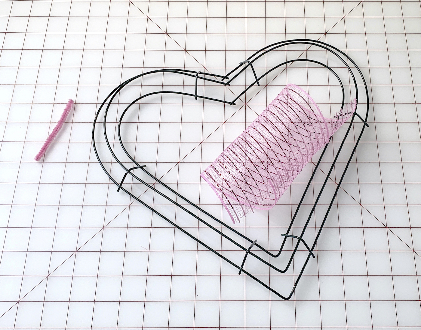 Heart wire wreath form, pipe cleaner, and piece of deco mesh